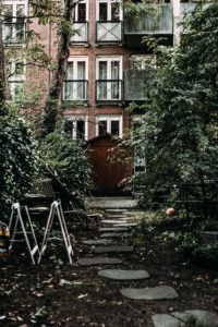 A paver stone path in an urban back yard