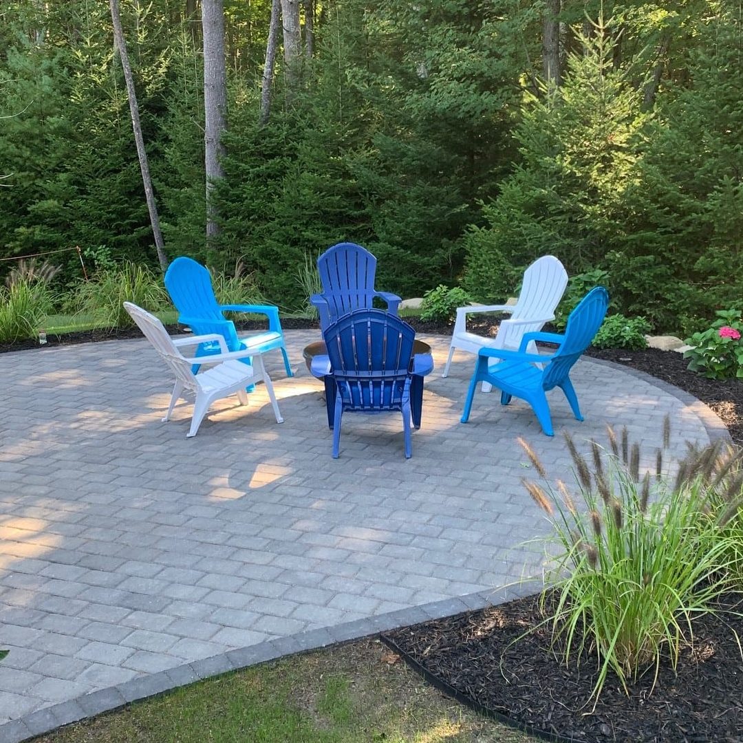 Chairs on a stone patio around a fire pit