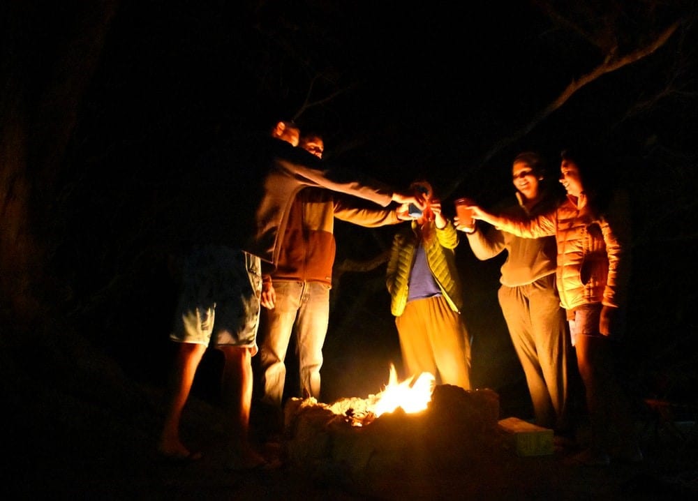 People gathered around a fire pit at night