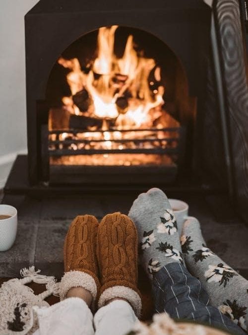 Feet snuggling by a cozy fireplace