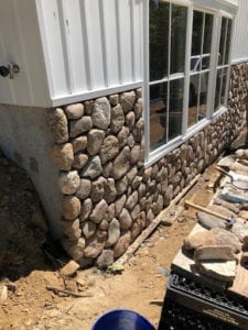 A stonewall veneer on the bottom of the wall.