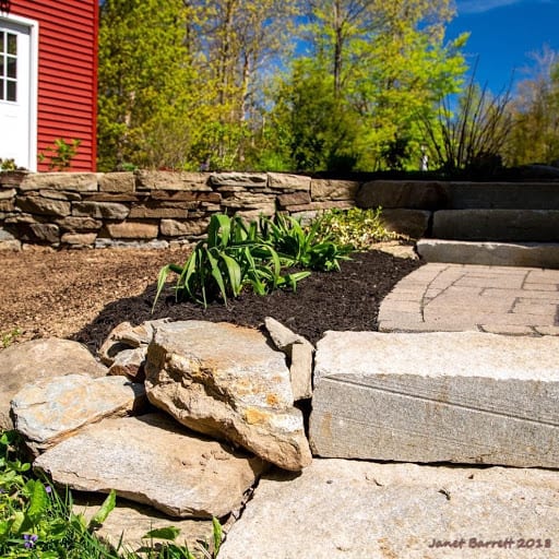 A well-landscaped yard with stone walkway.jpg