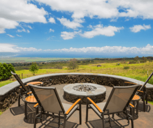 Custom stone firepit on the patio with seating wall over looking the ocean