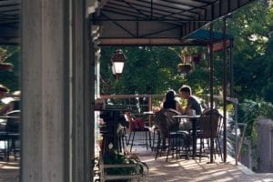 Couple sitting on a patio with hanging planters