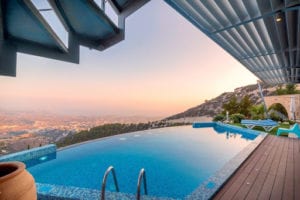 Over hang pool with view of a city