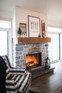 Stone fireplace with rustic wood mantel