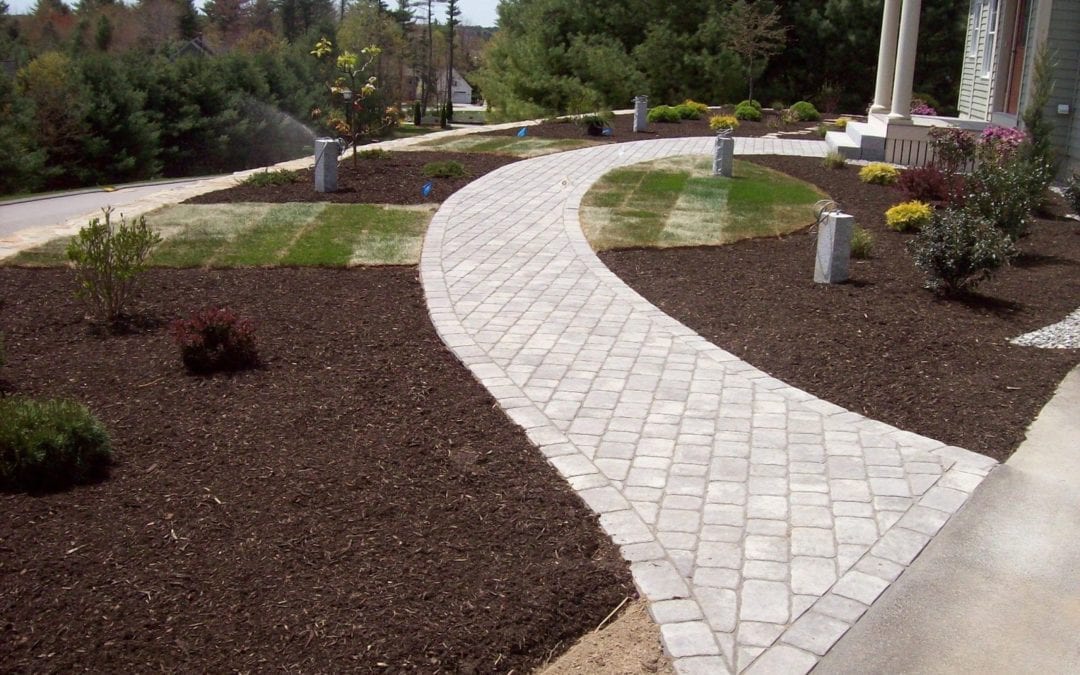 Stone walkway with clean landscaping at property in Maine