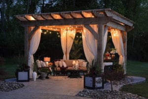 Welcoming outdoor patio with comfortable seating and lights.