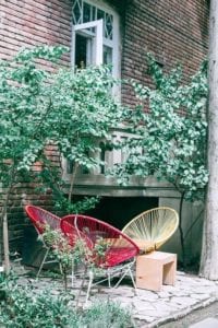 a stone wall and chairs 