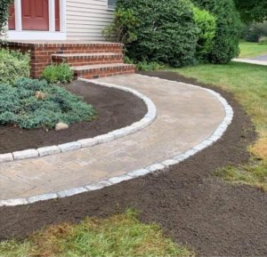 Landscaped stone walkway with shrubs