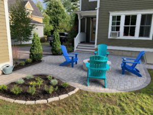 relaxing patio with adirondack chairs around a firepit
