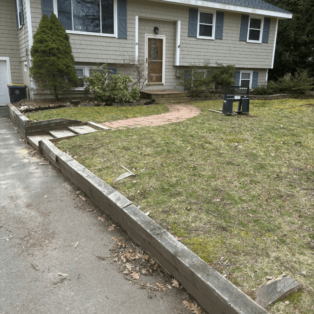 front yard with worn wood edging and steps