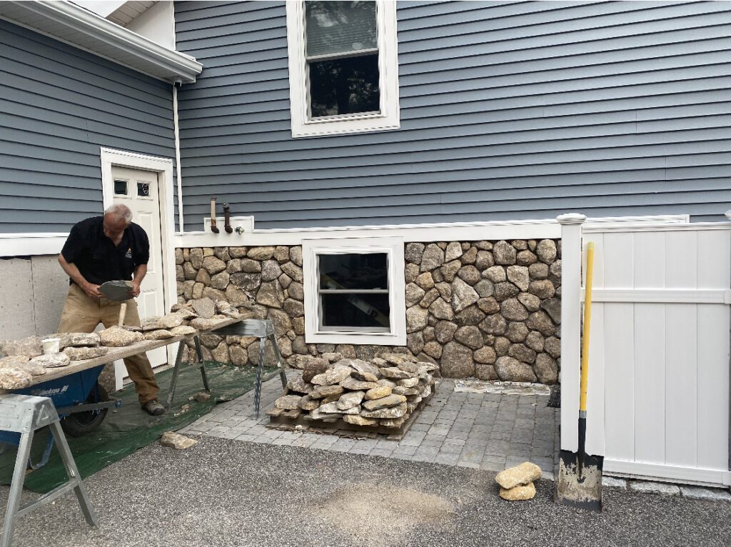 Stone Solutions Maine installing natural stone siding on home exterior