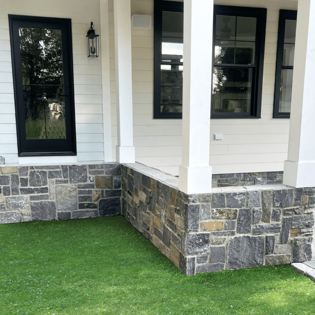 Natural stone siding on Maine home exterior