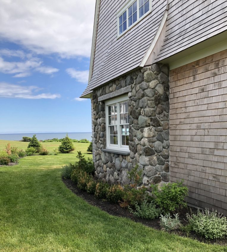 Natural stone siding on Maine home exterior