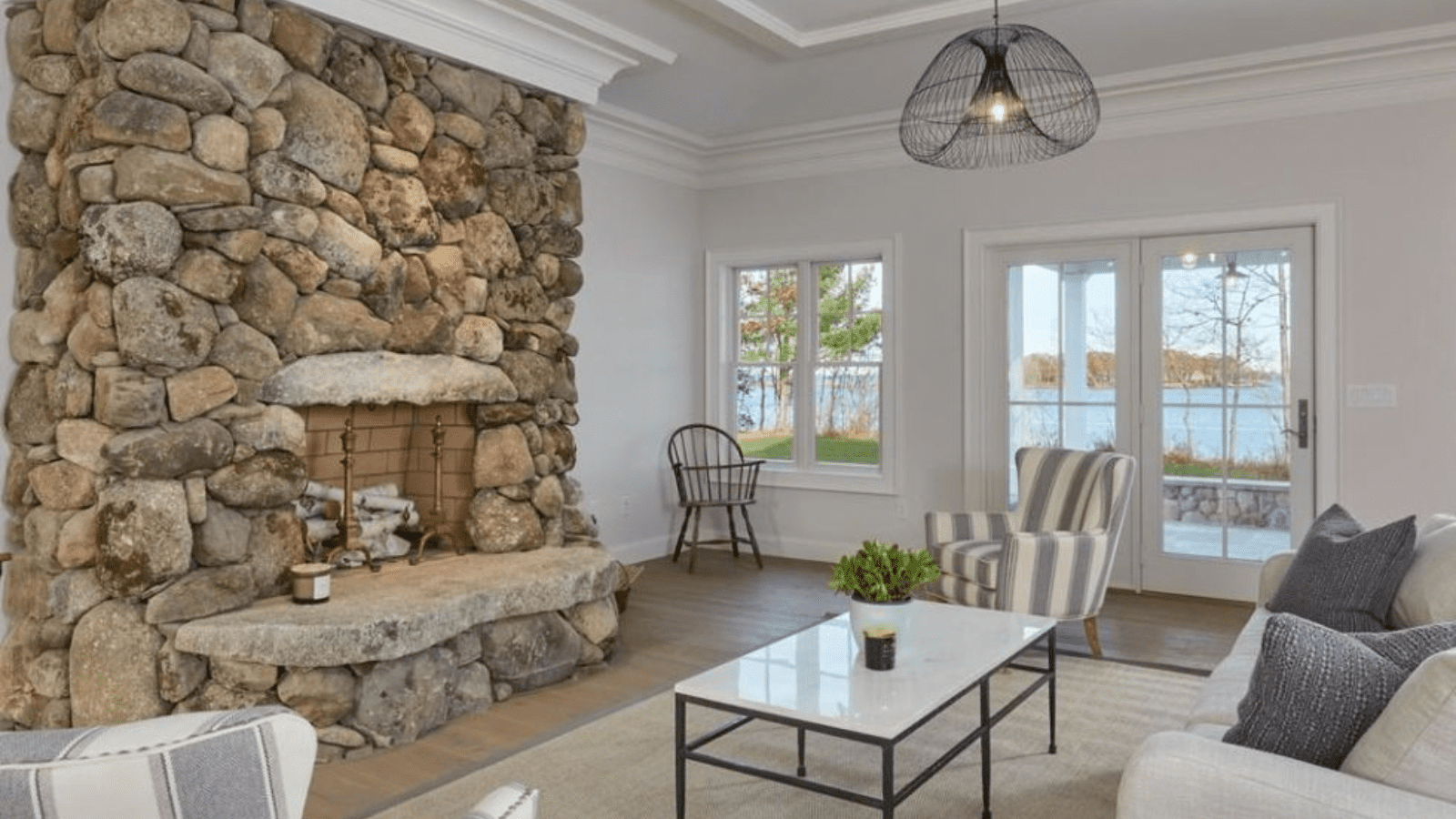 floor-to-ceiling-fieldstone-fireplace-coastal-living-room-maine
