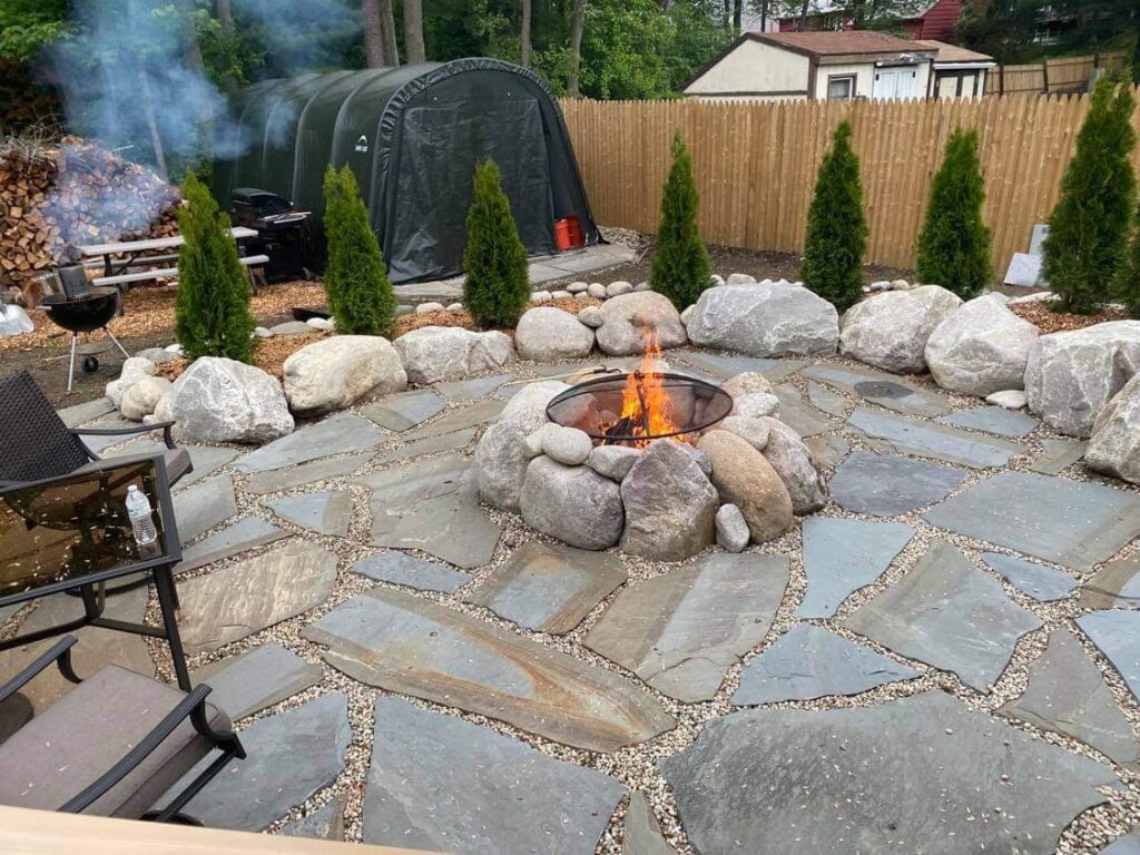 Natural stone patio with boulder fire pit