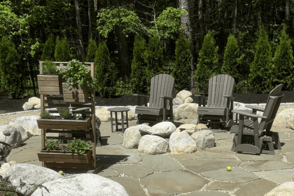 Natural stone patio with boulder fire pit