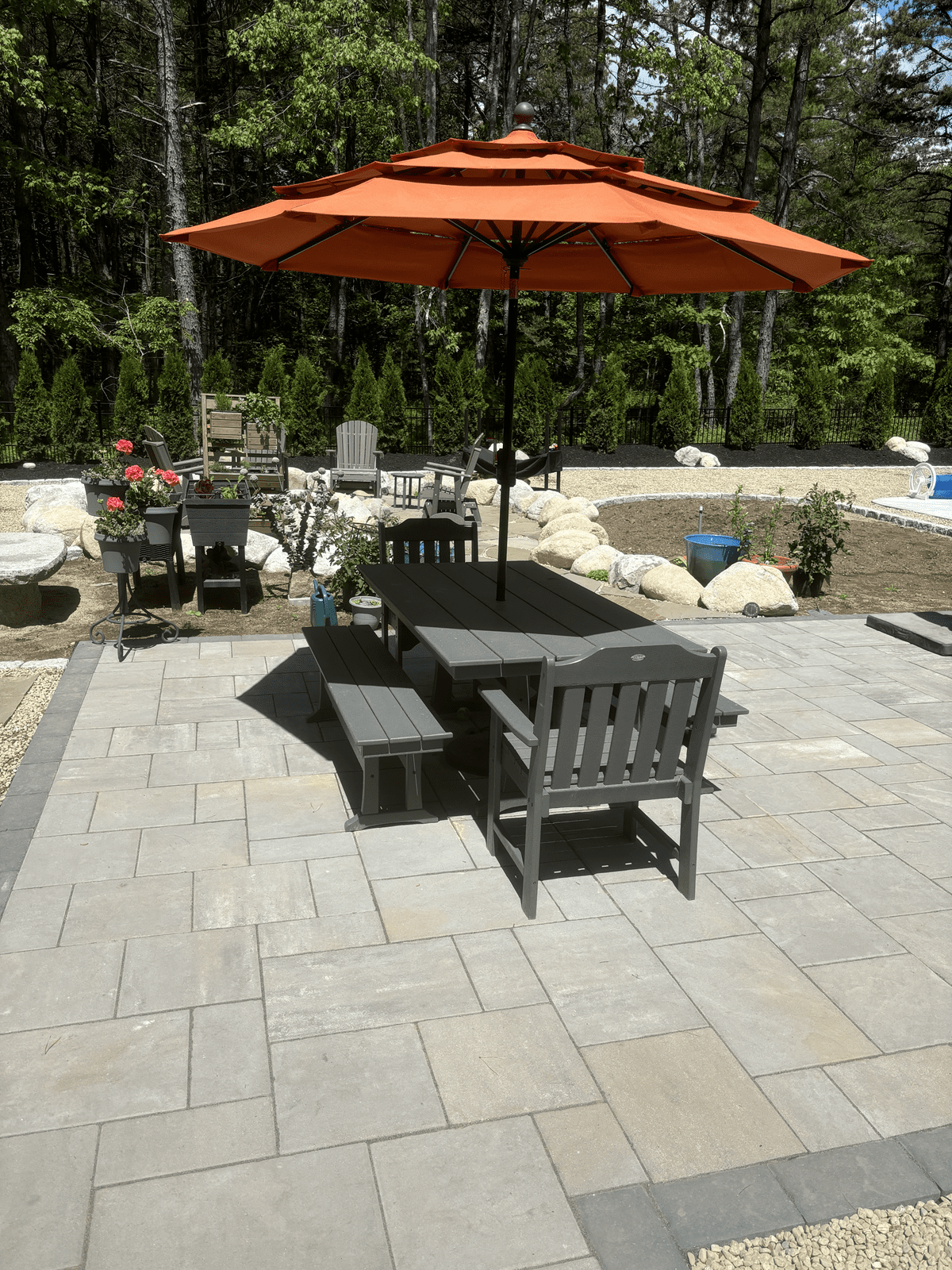 paver-patio-outdoor-dining-umbrella-boulder-landscaping-maine