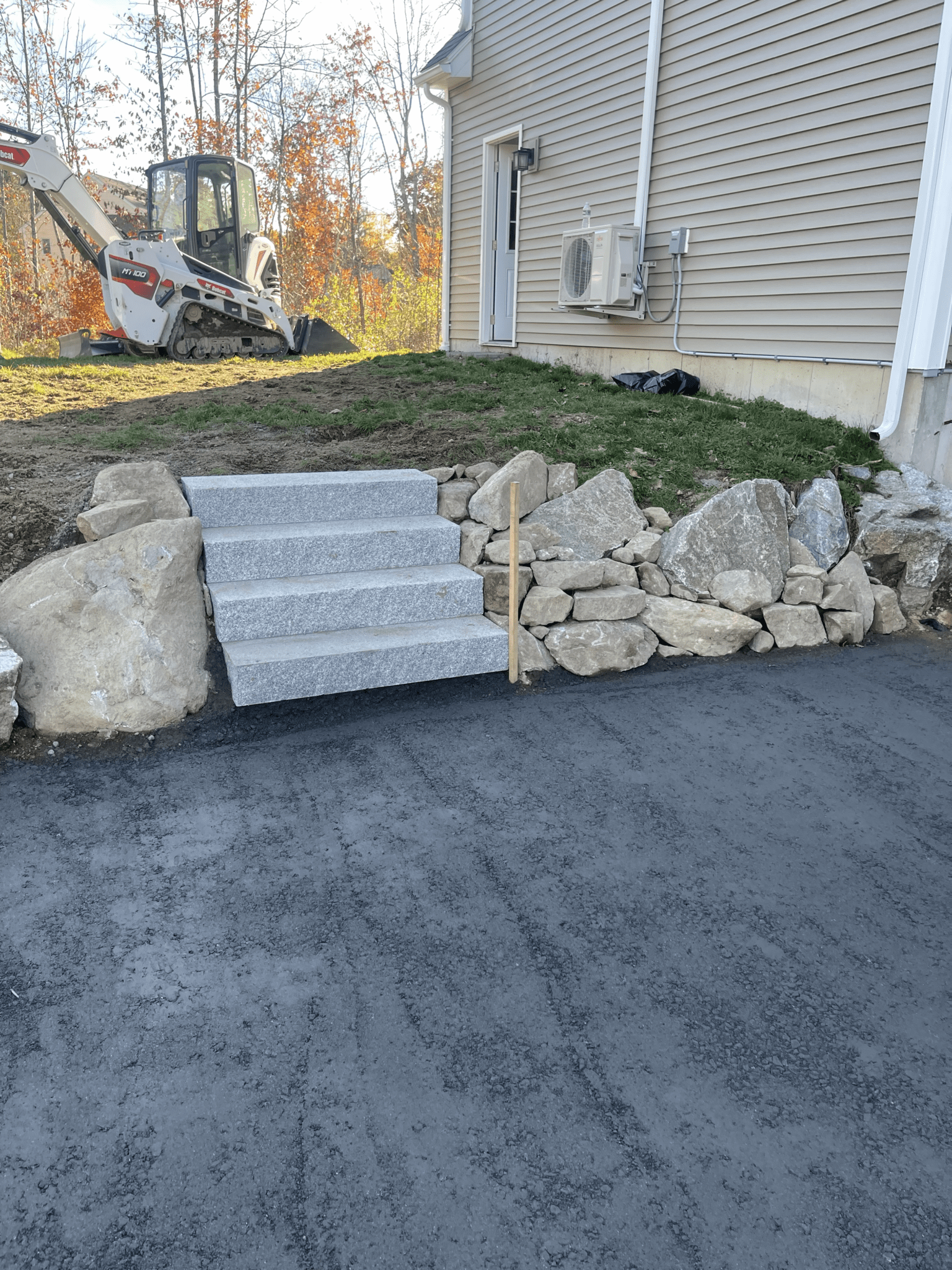 granite-steps-boulder-retaining-wall-asphalt-driveway-maine