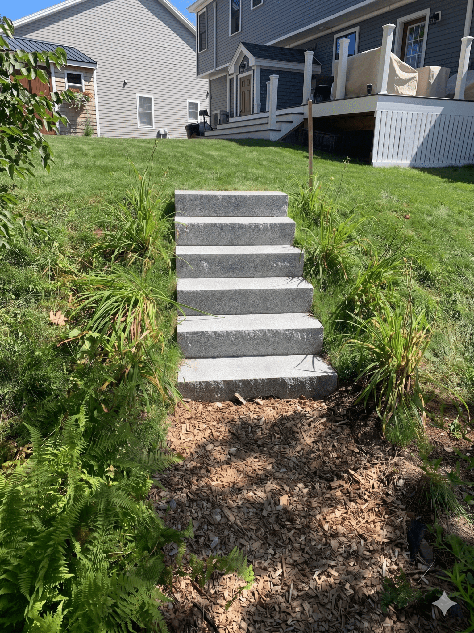 granite-steps-sloped-backyard-mulch-landscape-maine
