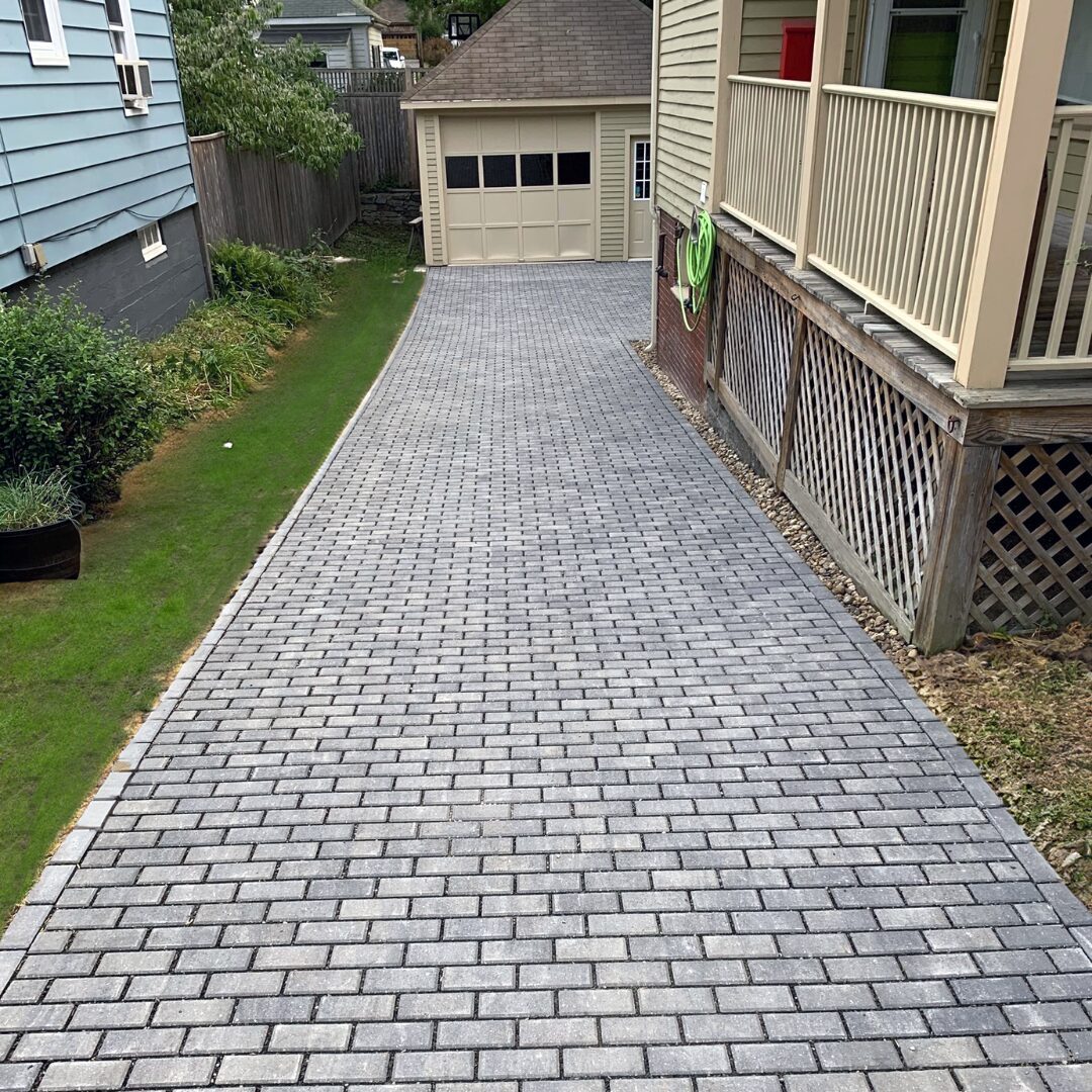 gray-brick-paver-driveway-side-entry-garage-access