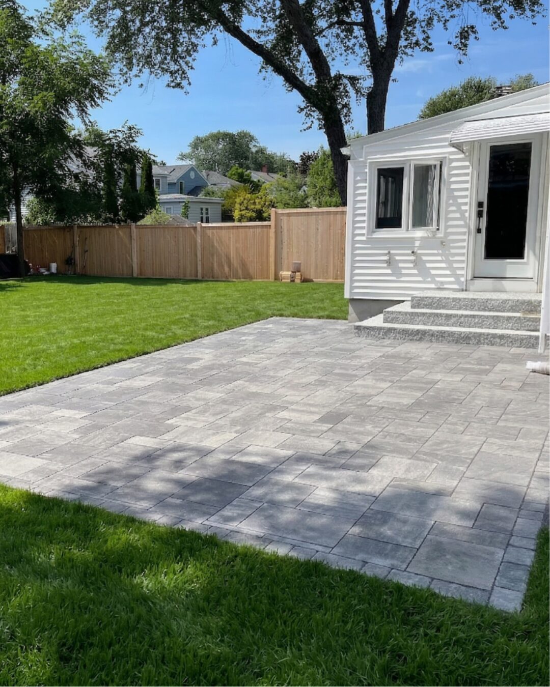 large-backyard-paver-patio-installation-granite-steps