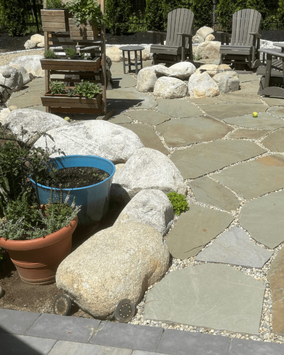 natural-flagstone-pathway-granite-boulder-border-outdoor-seating-area-maine