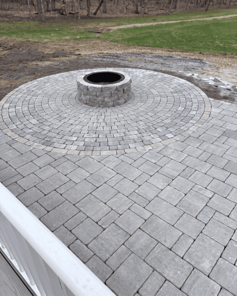Finished fire pit paver patio viewed from the deck of a Durham, Maine home