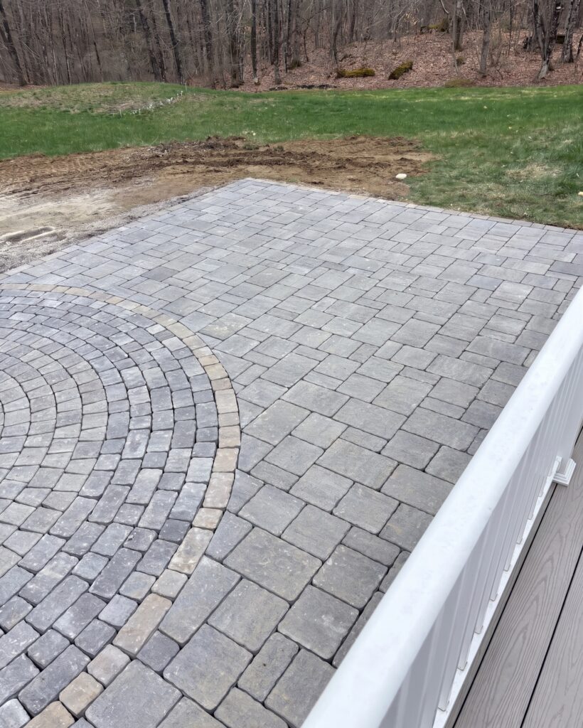 Genest Grand Katahdin paver patio field meeting the circle pack border in Durham, Maine