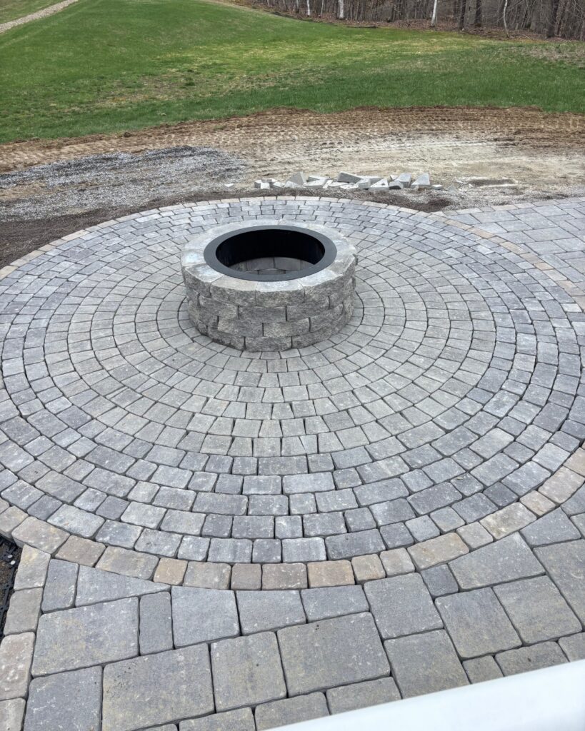 Small Katahdin circle pack surrounding a granite block fire pit on a Durham, Maine paver patio